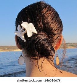Girl with earrings at the beach in the evening