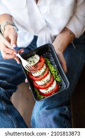 girl eating caprese from individual packaging, healthy food, Italian cuisine, Mediterranean diet - Shutterstock ID 2101813873