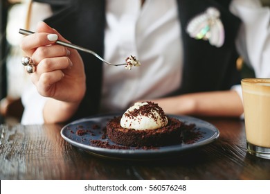 Girl eating chocolate desert brown with white cream - Powered by Shutterstock