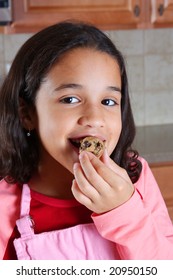 Girl Eating Cookie Dough In The Kitchen