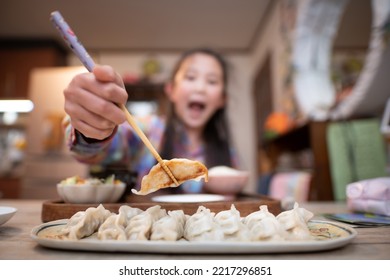 Girl Eating Dumplings With Chopsticks