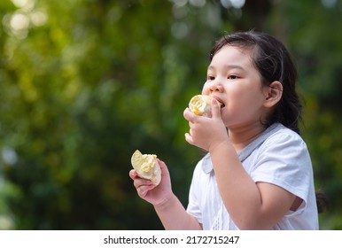 Girl eating durian with happy face. Tropical seasonal fruit, king of fruit from Thailand. - Shutterstock ID 2172715247