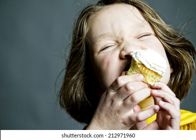 Girl Eating Frosted Cupcake