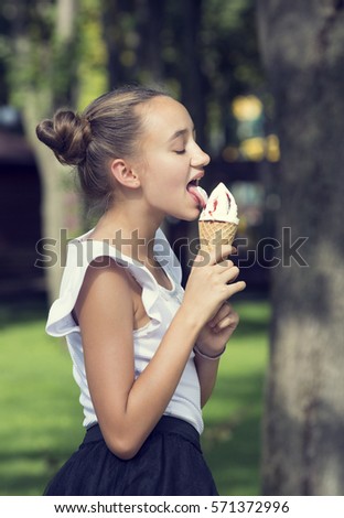 Girl eating ice cream in the park 