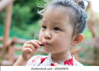 Girl Eating Raisins