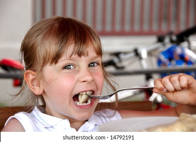 Girl Eating Ravioli In Restaurant