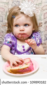 Girl Eating A Slice Of Cake And Making A Mess