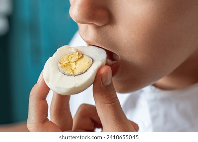 girl eating tasty egg, close up mouth. Health care, loss weight people concept. - Powered by Shutterstock