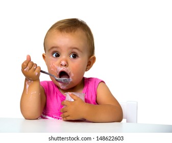 girl eating yogurt isolated on white