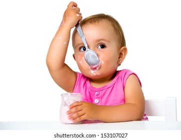 girl eating yogurt isolated on white