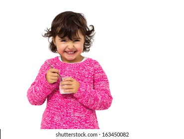girl eating yogurt isolated on white