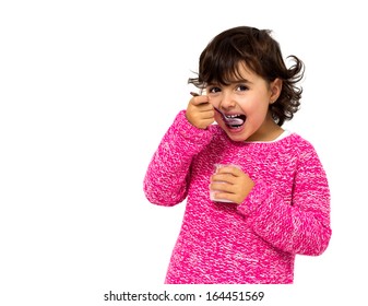 girl eating yogurt isolated on white