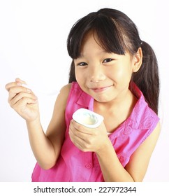 girl eating yogurt isolated on white