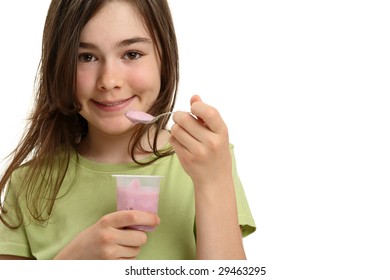 Girl eating yogurt isolated on white background