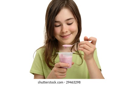 Girl eating yogurt isolated on white background