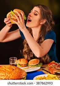 Girl Eats With Appetite Fastfood Big Hamburger And Fried Potatoes .