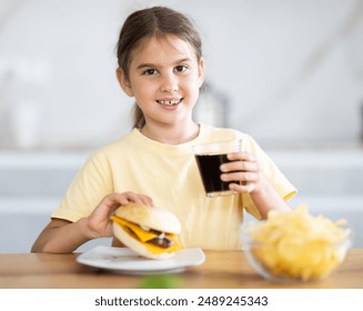 Girl eats burger and drinks cola - Powered by Shutterstock