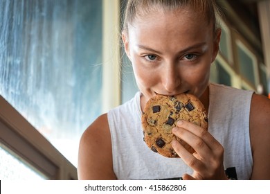 The girl eats cookie and has coffee, the fashionable girl, a smile, the girl with phone