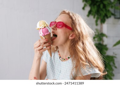 girl eats ice cream balls in hot summer, escape from the girl in pink glasses eats ice cream balls in the hot summer, escape from the heat - Powered by Shutterstock