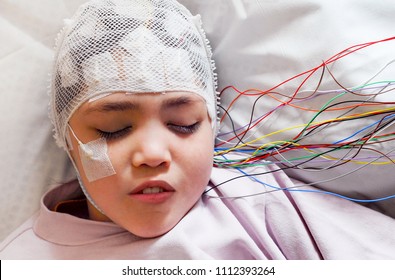 Girl with EEG electrodes attached to her head for medical test - Shutterstock ID 1112393264