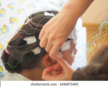 Girl With EEG Electrodes Attached To Her Head