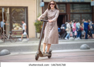 Girl In Electric Scooter Riding In The  Old City Center