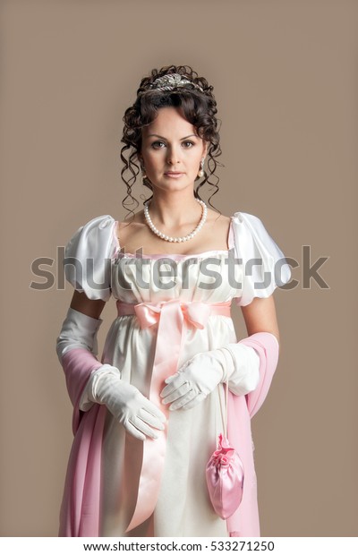 Girl\
in the Empire style dress with a glass of\
champagne