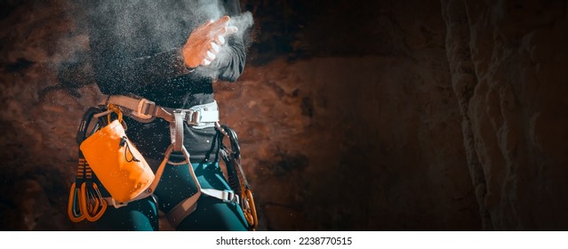 The girl is engaged in rock climbing, uses white powder of magnesia, claps her hands close-up, the woman leads an active lifestyle, climbs the mountains outdoor. - Powered by Shutterstock