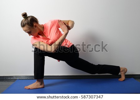 Girl is engaged in yoga, deep lunge for stretching