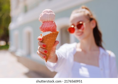 girl enjoying ice cream in a cone with ice cream balls