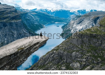 girl enjoying view from Troll Tongue edge in Norway