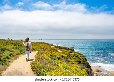 Girl enjoying walk in the park by the ocean.  Woman hiking alone on vacation. Summer mountain coastal landscape. View from highway 1. Big Sur, California, USA. - Shutterstock ID 1731445375