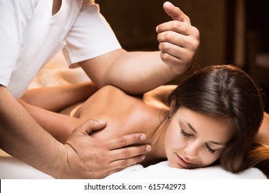 The girl enjoys deep tissue massage - Shutterstock ID 615742973