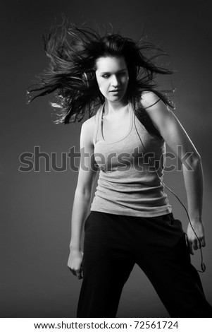 Similar – Close up front upper body portrait of one young athletic woman in sportswear in gym over dark background, looking at camera