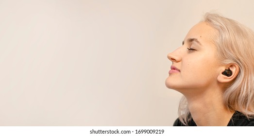 Girl enjoys music in wireless headphones. Modern technologies. Bluetooth. Without wires. - Powered by Shutterstock