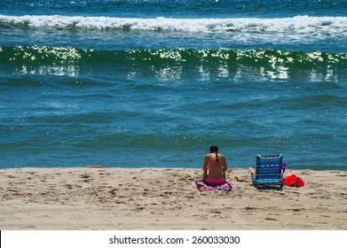  A girl enjoys quiet time on the beach on Long Beach Island in New Jersey.