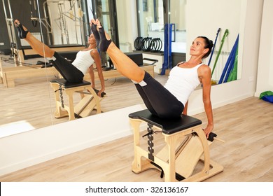 Girl Is Exercising Pilates Using Pilates Chair