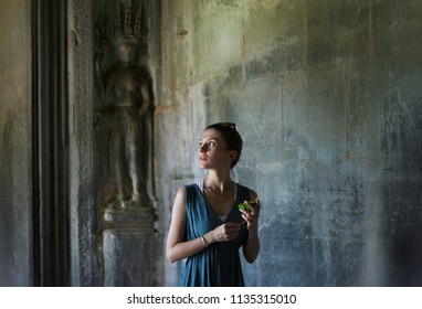 Girl Explores Mystical Ancient Temple Ruin With Lotus Flower In Hand. South East Asian Tourism