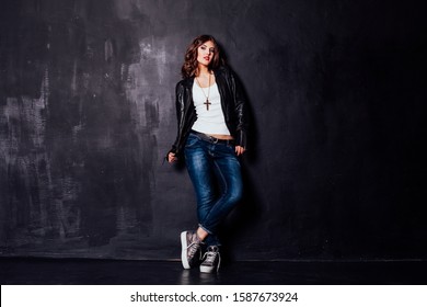 Girl In Fancy Leather Jacket Pitchman Style On A Black Background