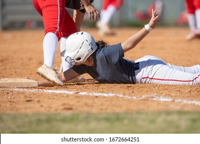 Girl Fastpitch Softball Player In Action During A Competitive Game