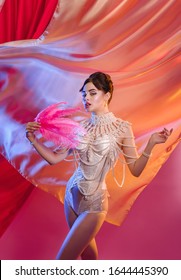 A Girl With Feathers In Her Hands In A Pearl Decoration In A Burlesque Show