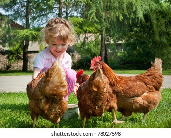 Girl Feeding Chickens