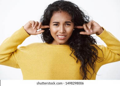 Girl Feeling Discomfort From Loud Annoying Music, Shut Ears With Fingers, Frowning Displeased, Dislike Hearing Noisy Sounds, Frowning Bothered, Asking Turn Volume Down, White Background