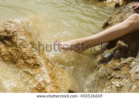 girl with feet in ocean water