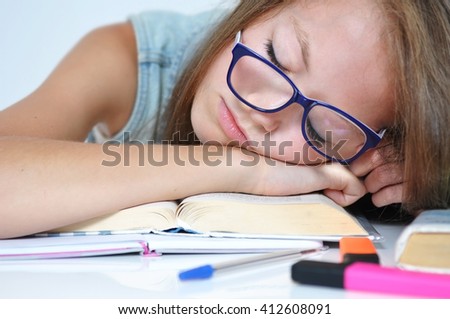 Girl fell asleep on her homework because she was bored