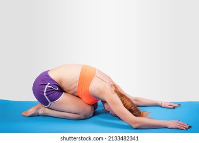 Girl In Fetal Position, On A Gray Background. High Quality Photo