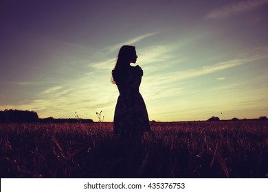 Girl in the field on sky background sunset - Powered by Shutterstock