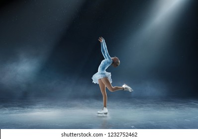 Girl figure skating at ice arena