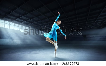 Girl figure skating at ice arena