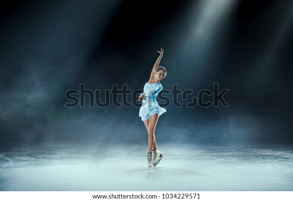 girl figure skating at ice\
arena